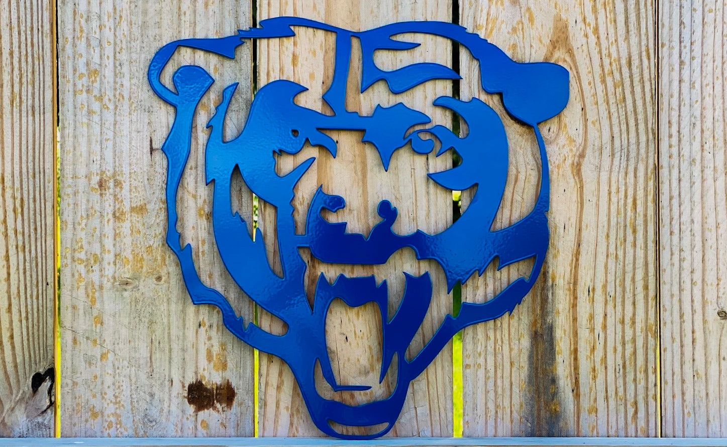 blue bear metal sign display on fence