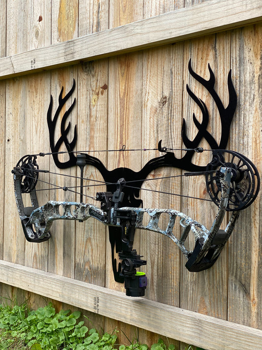 black metal rack holding a bow 